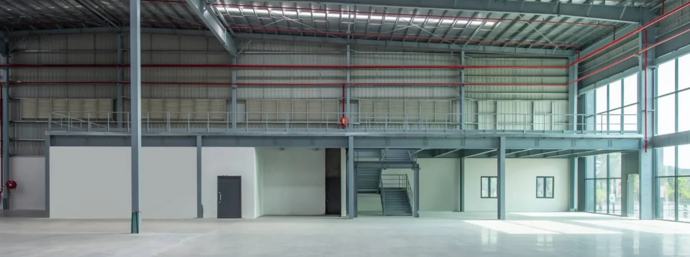 Clear-span warehouse interior with mezzanine and high roof