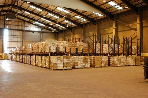 Selective pallet racking stacked with cartons on wooden pallets